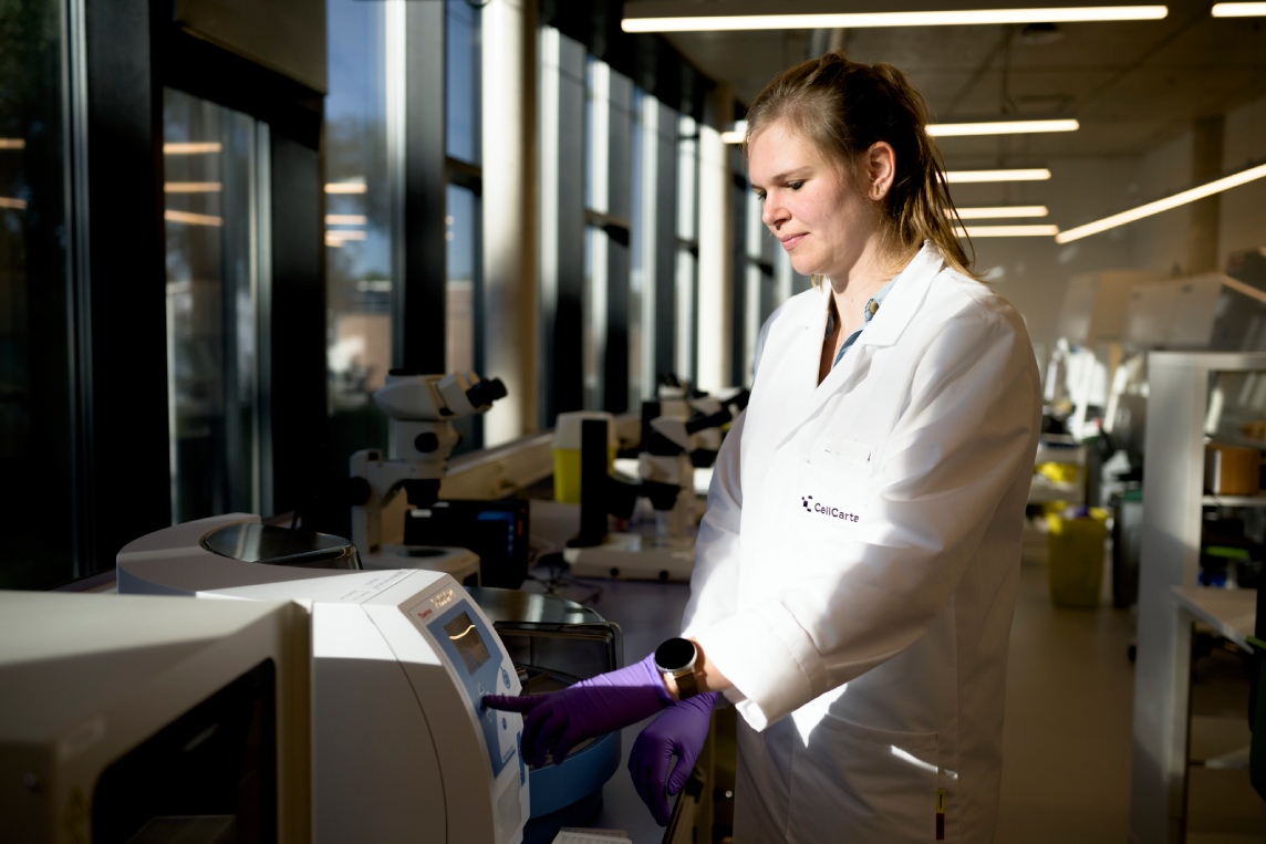 Scientist in a laboratory instrument aisle.