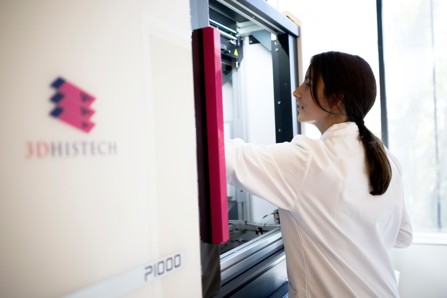 Scientist operating a 3DHistech tissue imaging instrument.