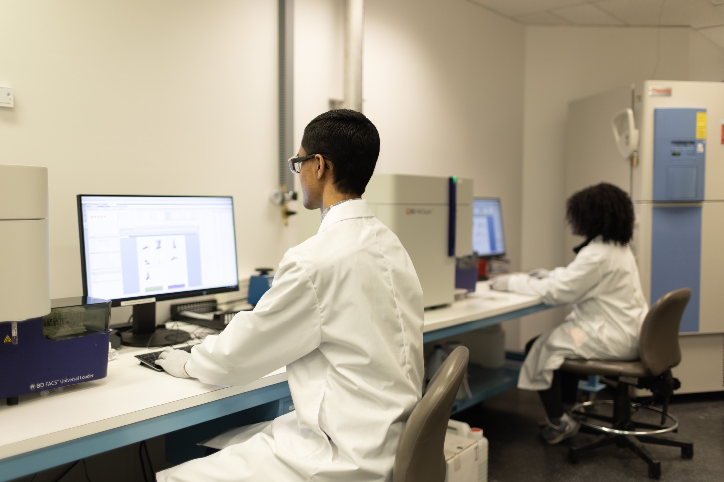 Scientists reviewing FluoroSpot clinical application data
