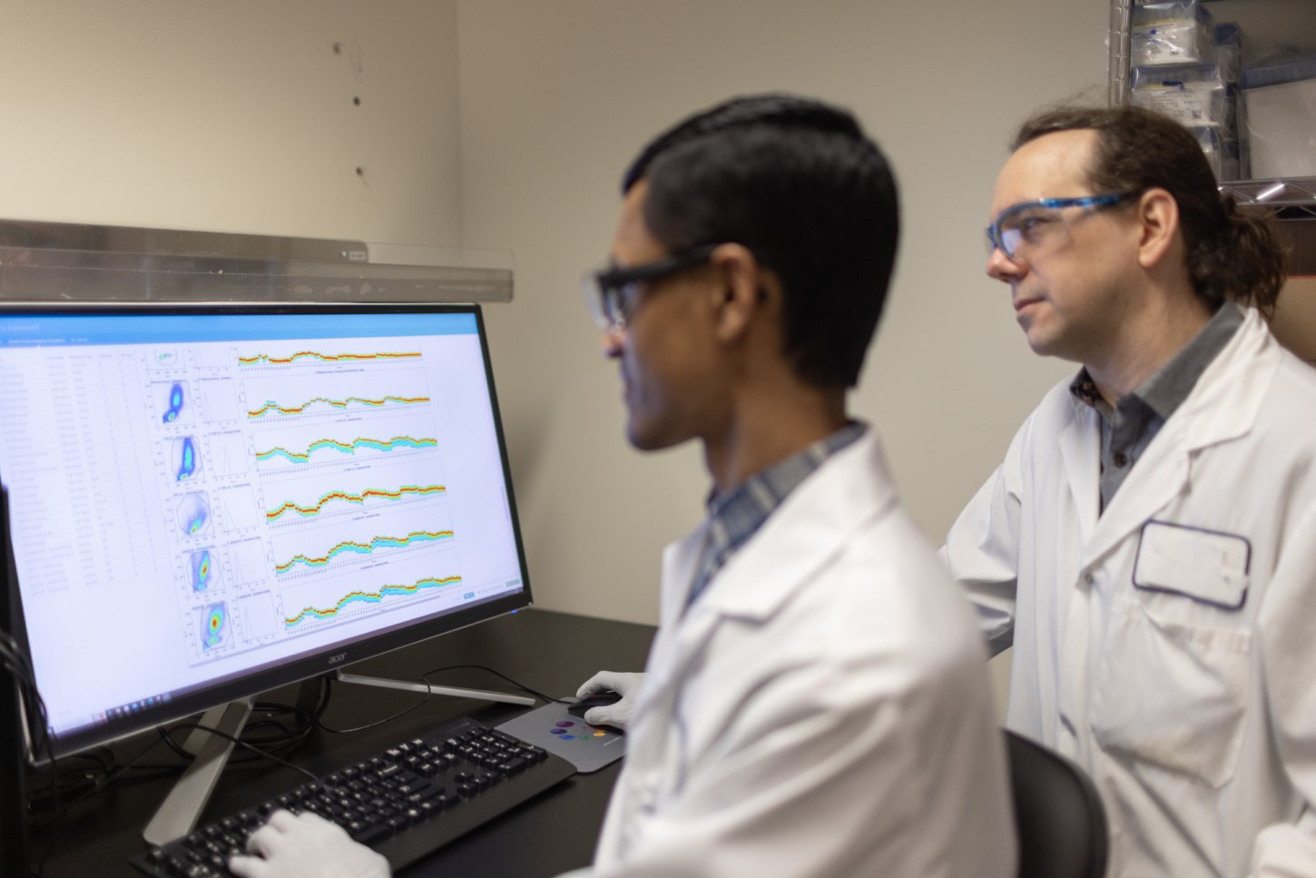 CellCarta flow cytometry scientists reviewing data at workstation
