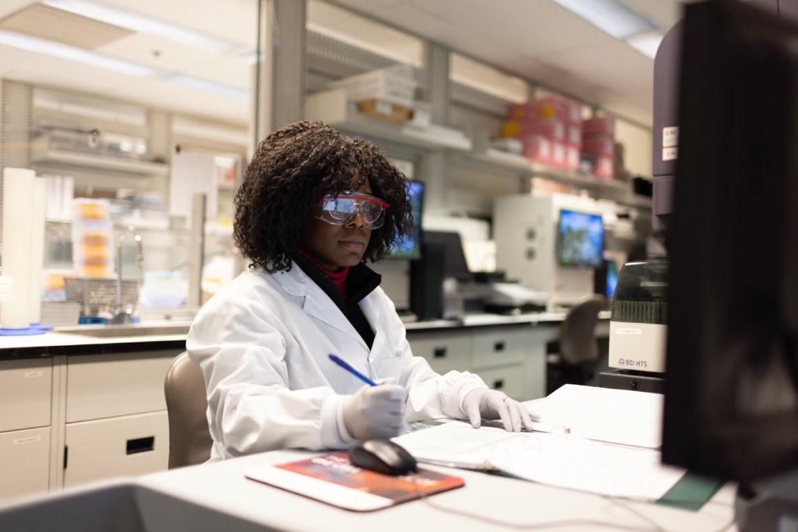 Scientist reviewing Ella™ high-performance ELISA multiplexing results