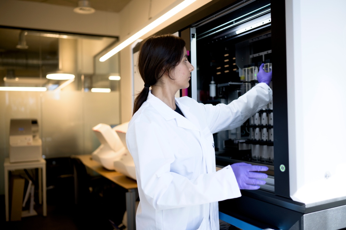 Scientist retrieving samples from laboratory storage.