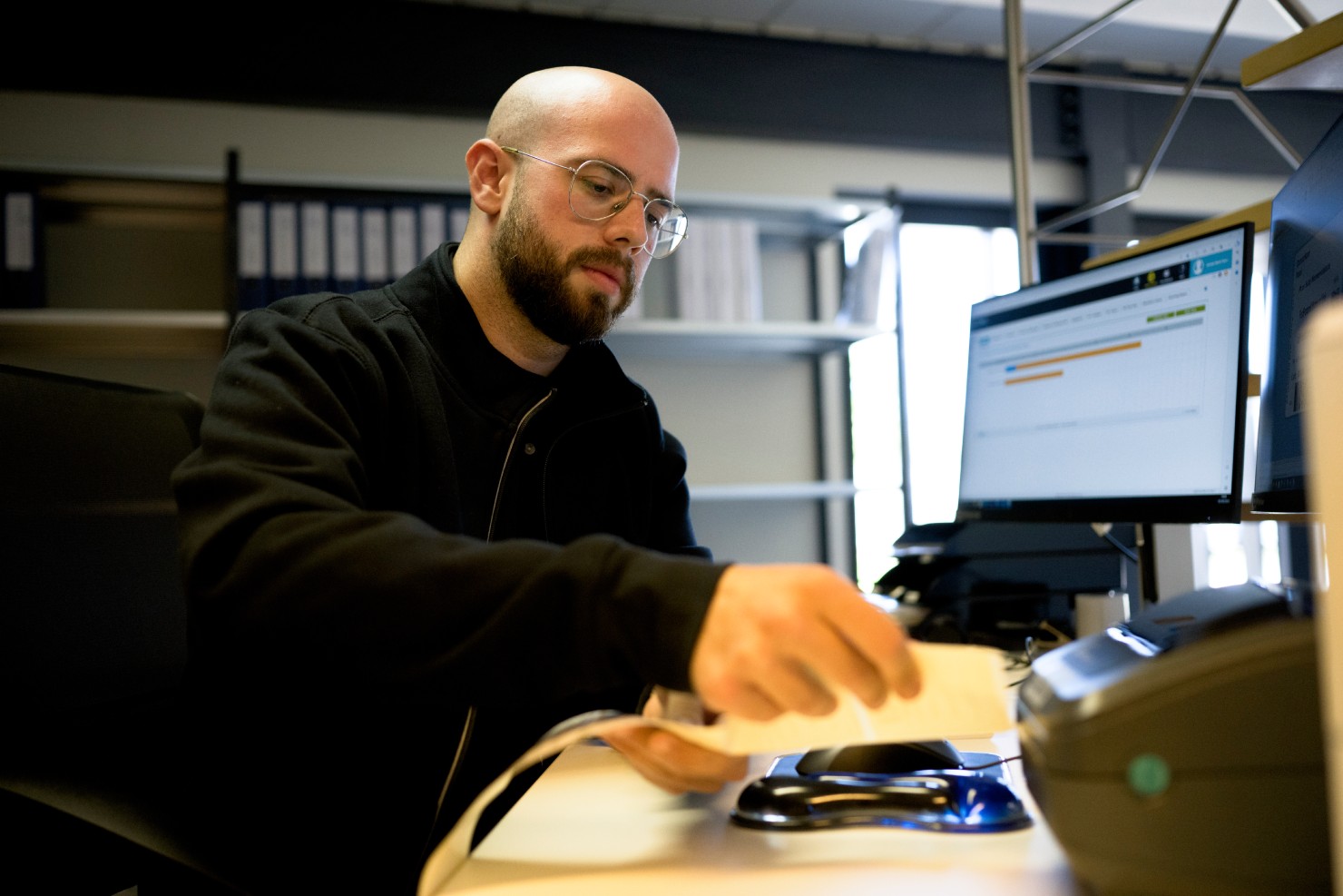 Scientist processing samples at a workstation for CellCarta IVDR services.