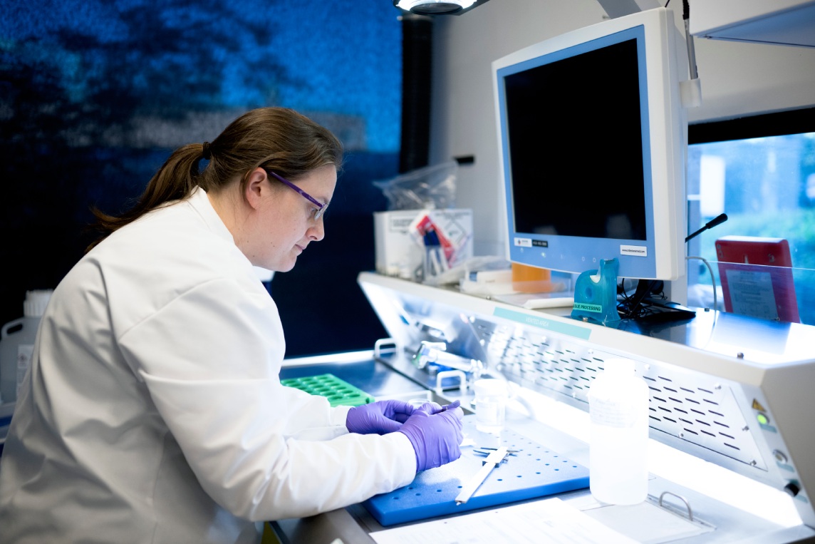 Scientist reviewing data at a laboratory workstation.