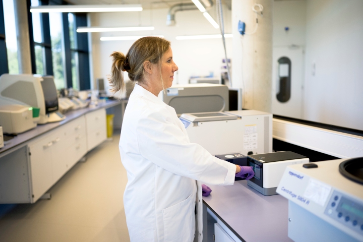 Scientist performing sequencing at a laboratory bench.