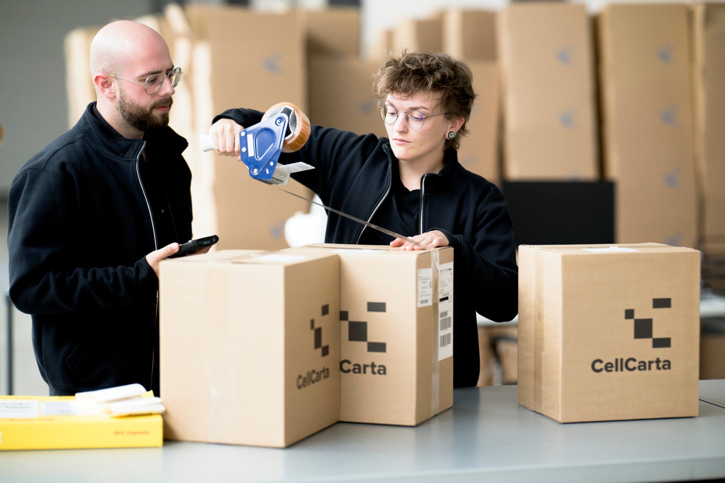 Team packing clinical trial sample kits into CellCarta shipping boxes.