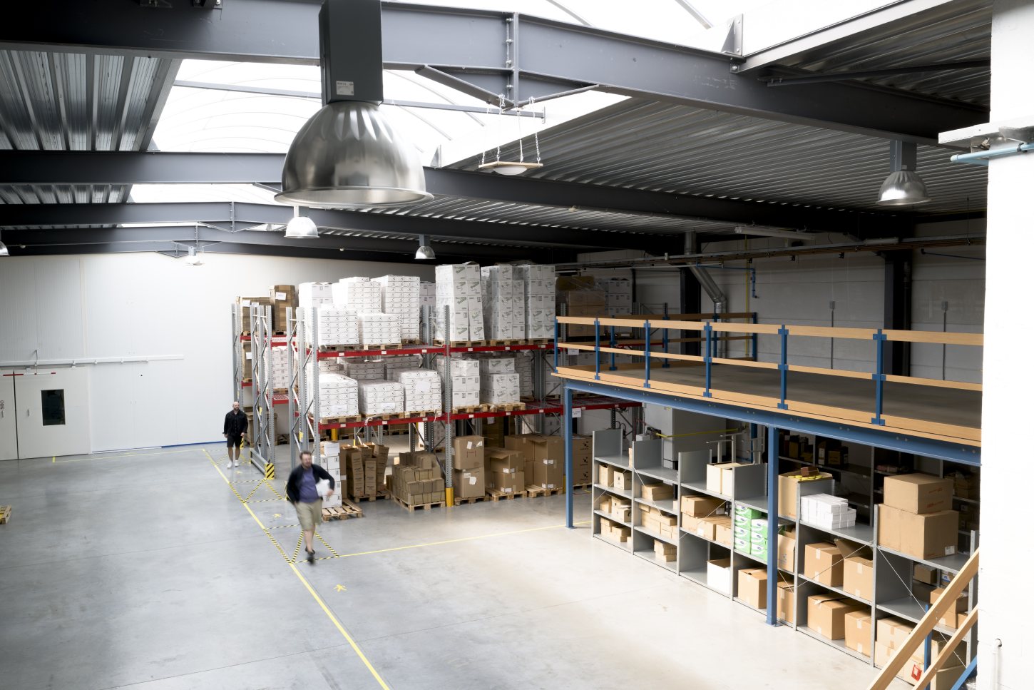 Clinical trial logistics warehouse with storage racks.