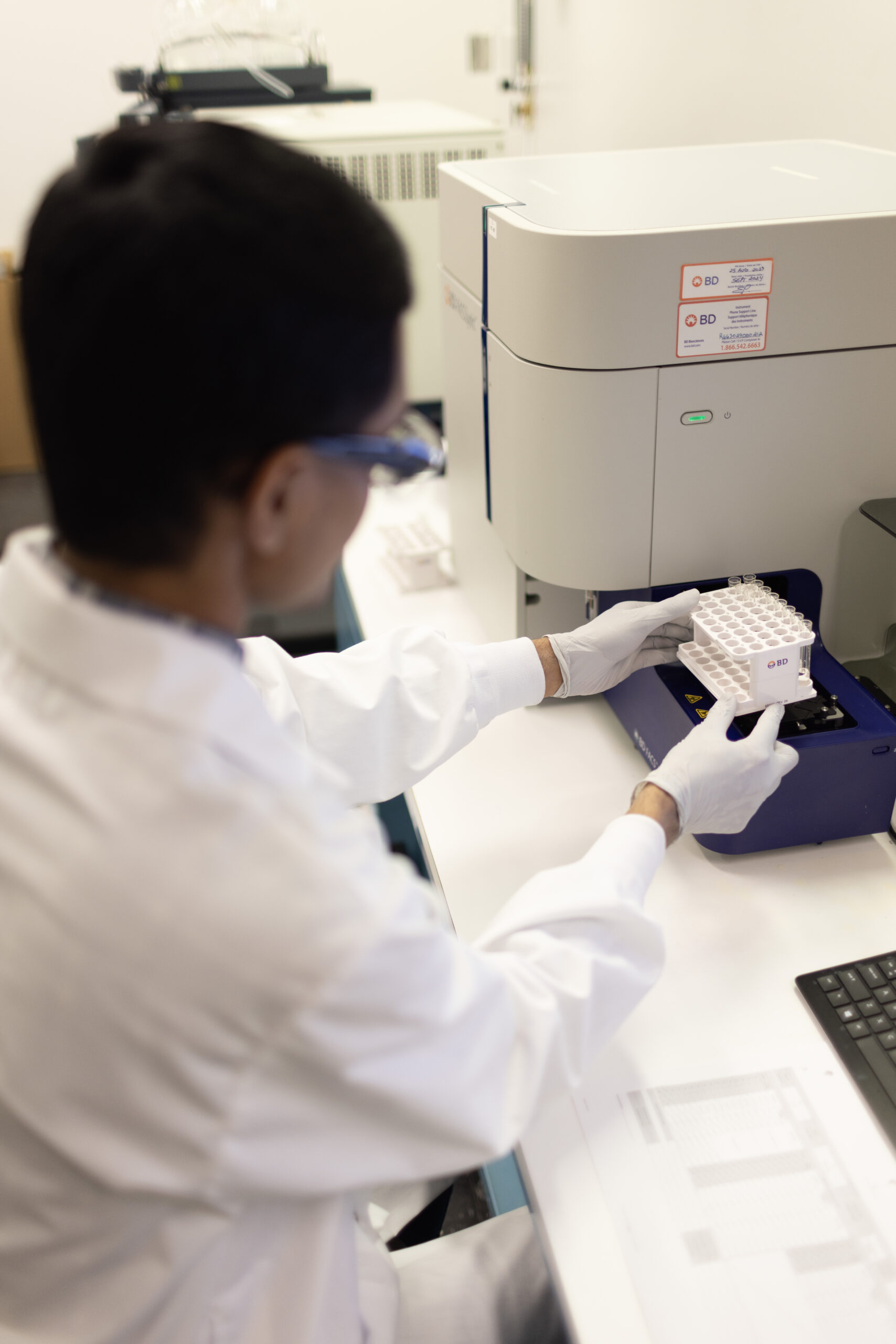 Scientist processing samples at a laboratory bench.