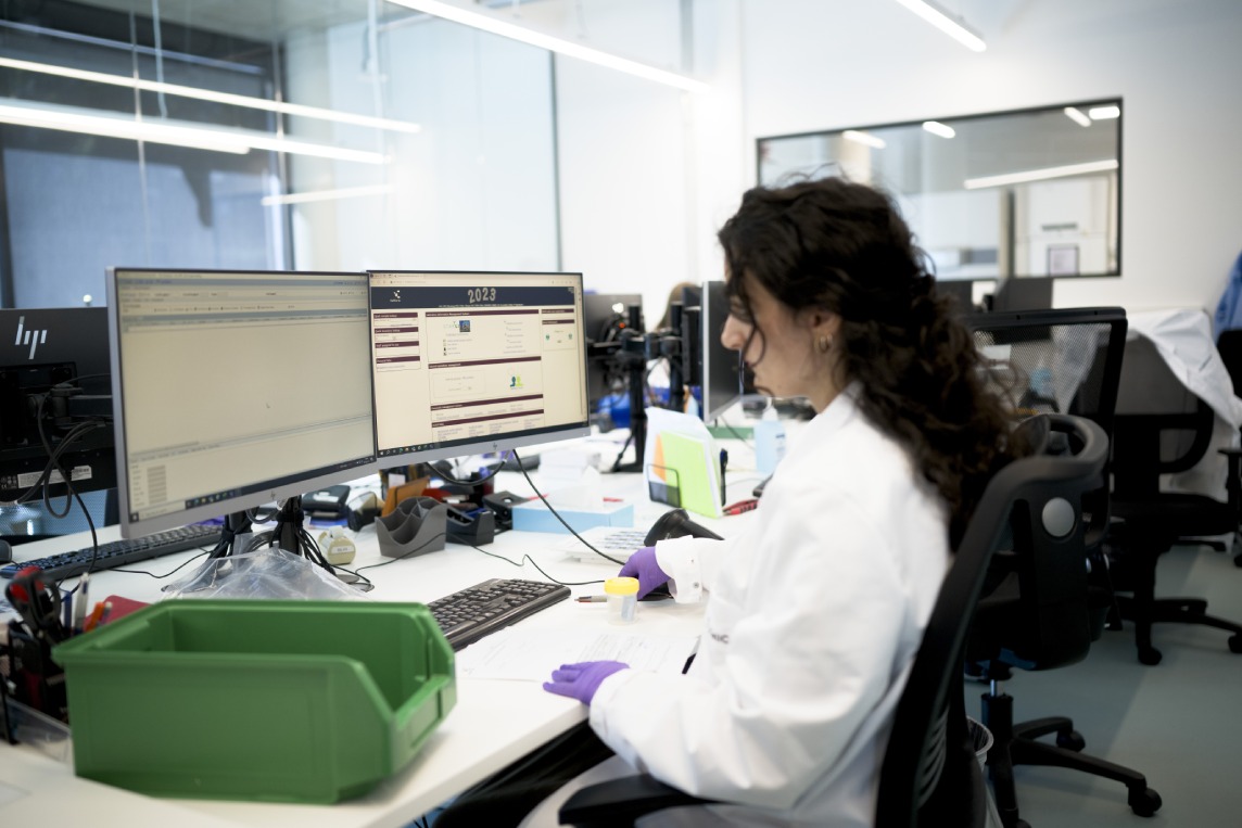 Scientist reviewing Antigen Atlas MHC peptide database for target prioritization