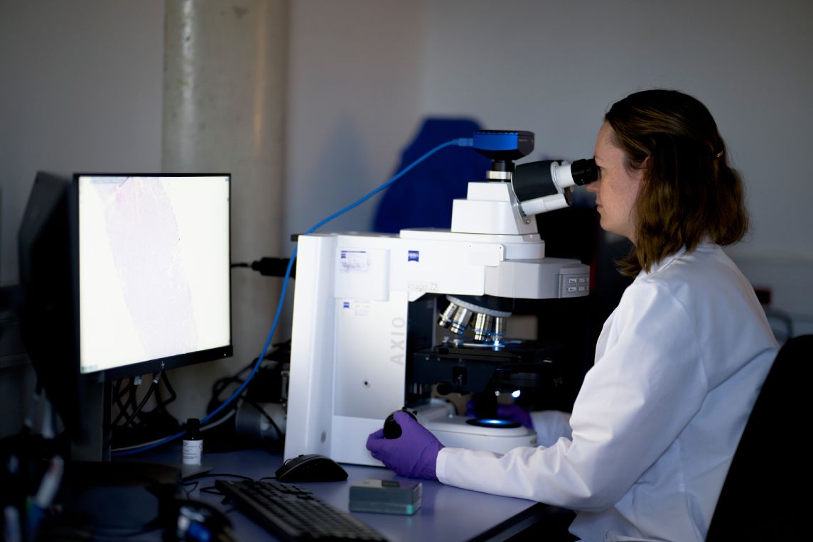 Biomarker scientist at microscope