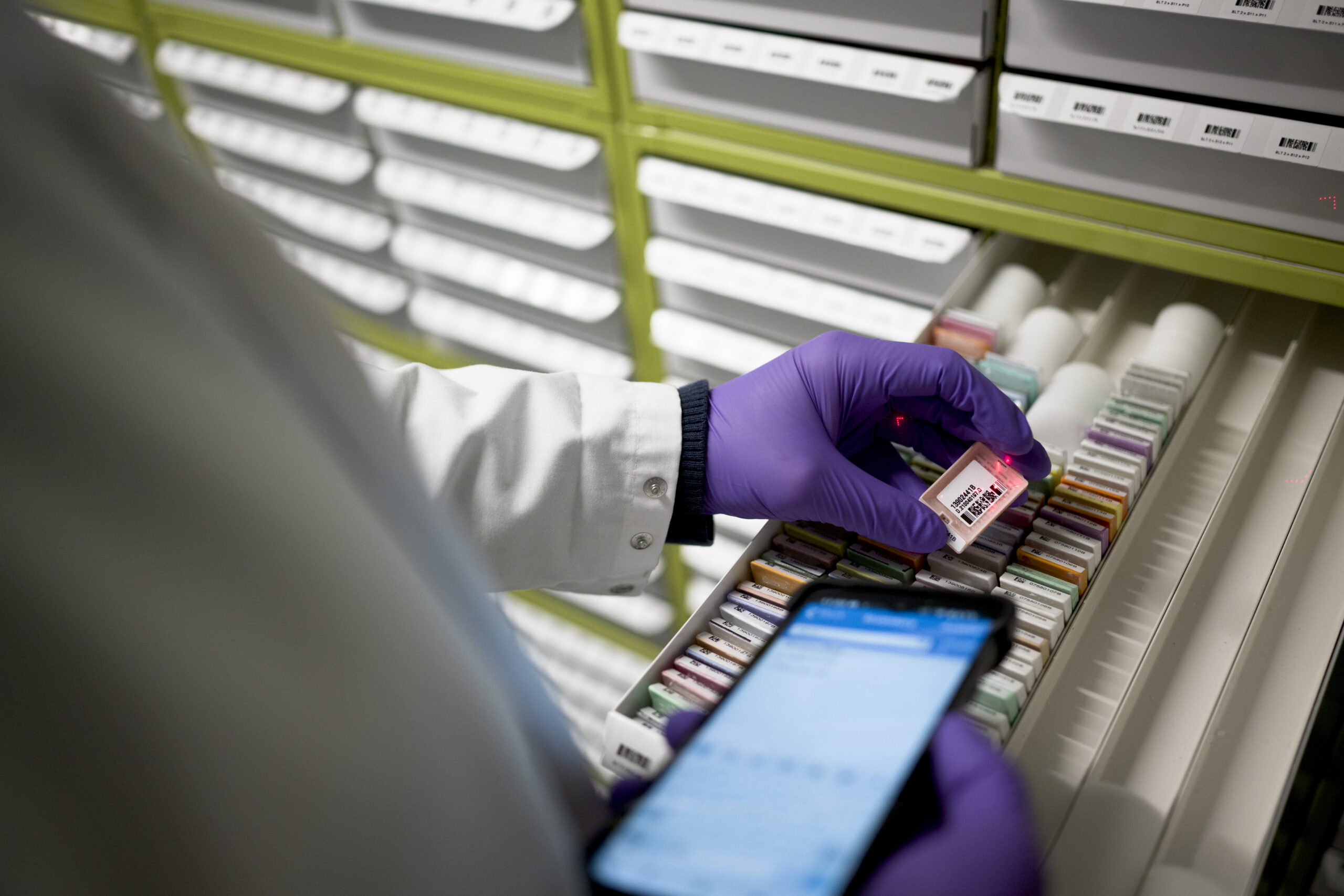 Scientist using a tablet to scan samples.