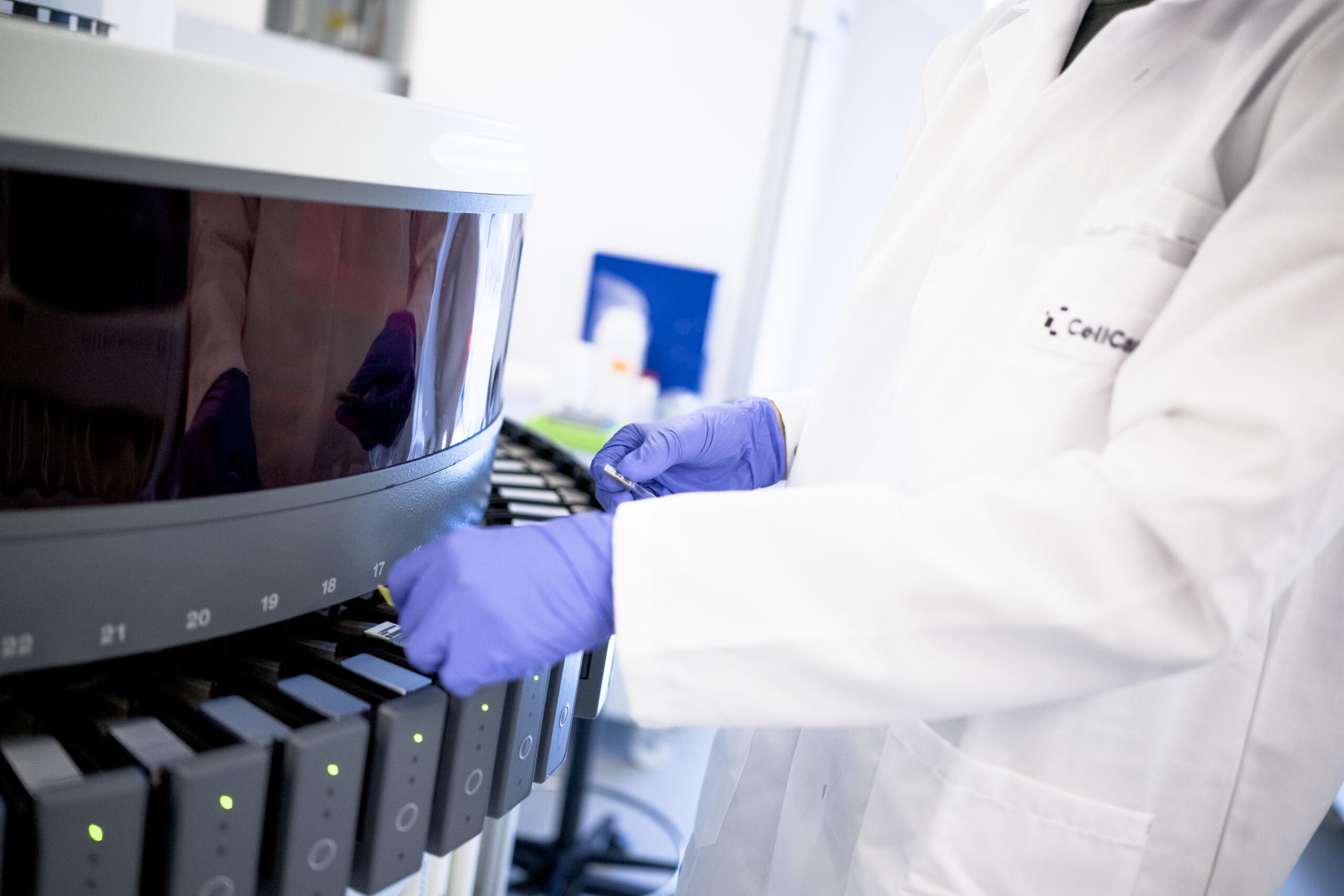 Gloved hands loading samples into the Benchmark Ultra.