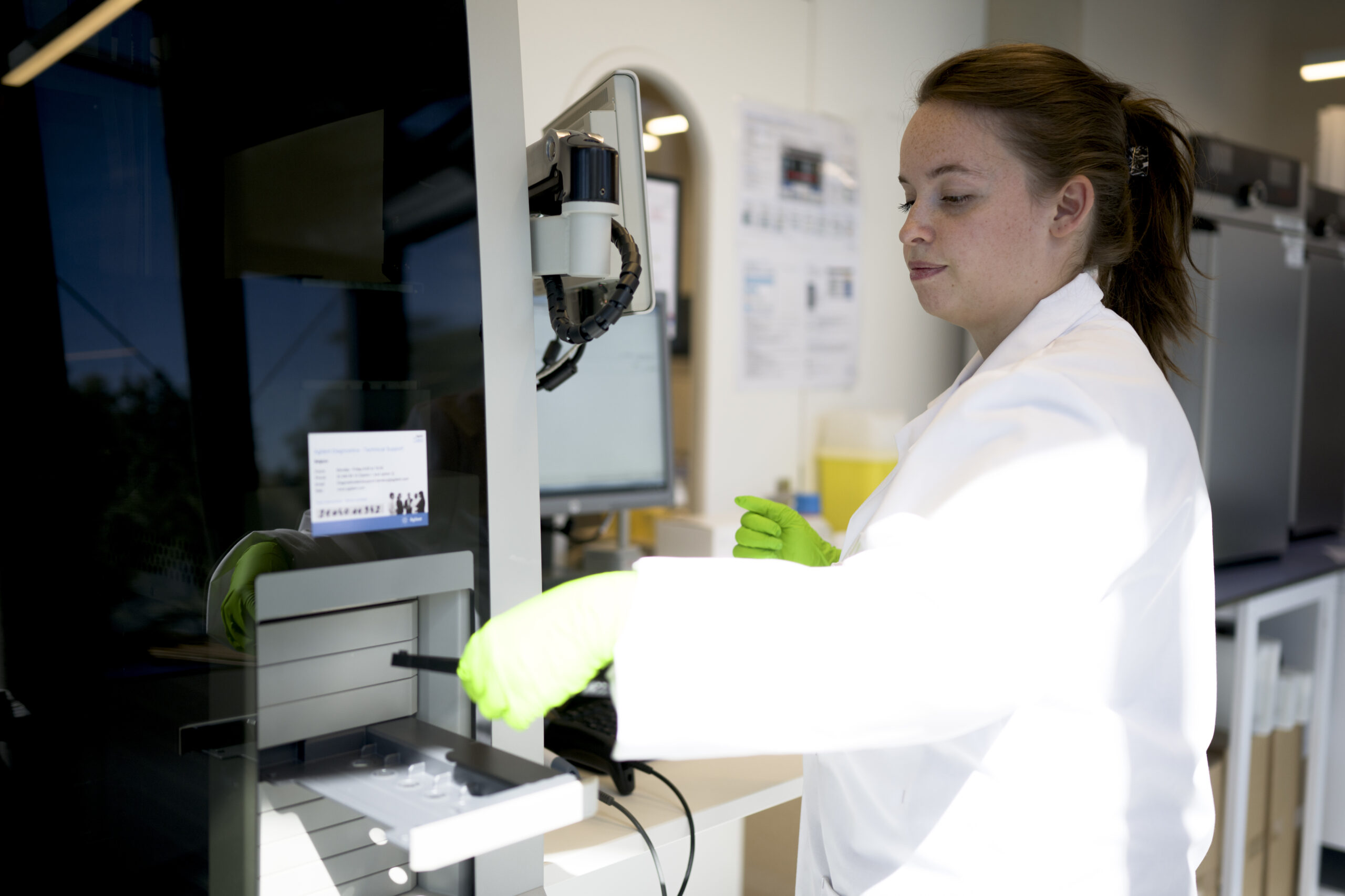 Scientist handling a sample at the laboratory bench.