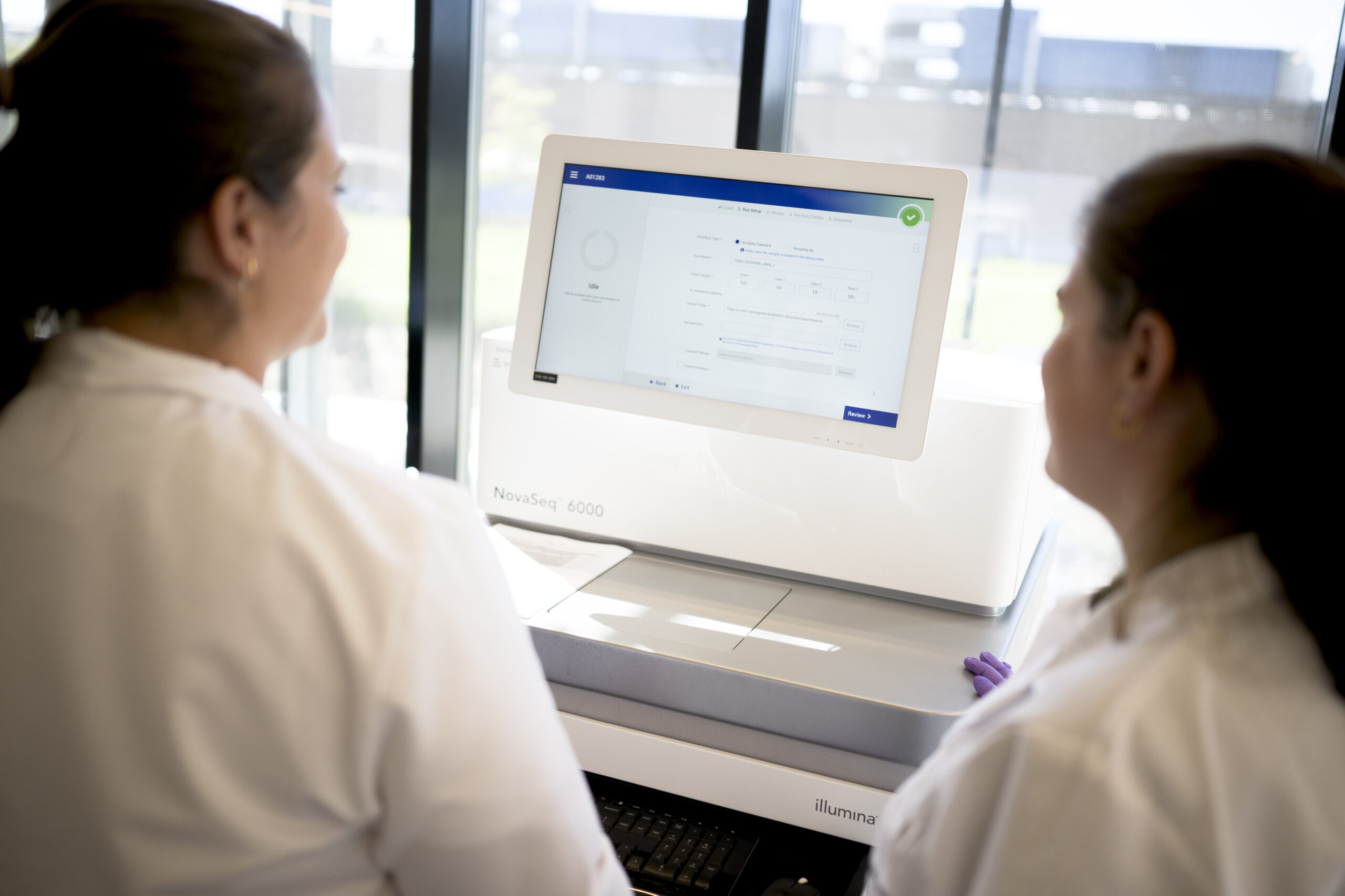 Scientist loading samples into NovaSeq X Plus next-generation sequencing platform in a CellCarta laboratory