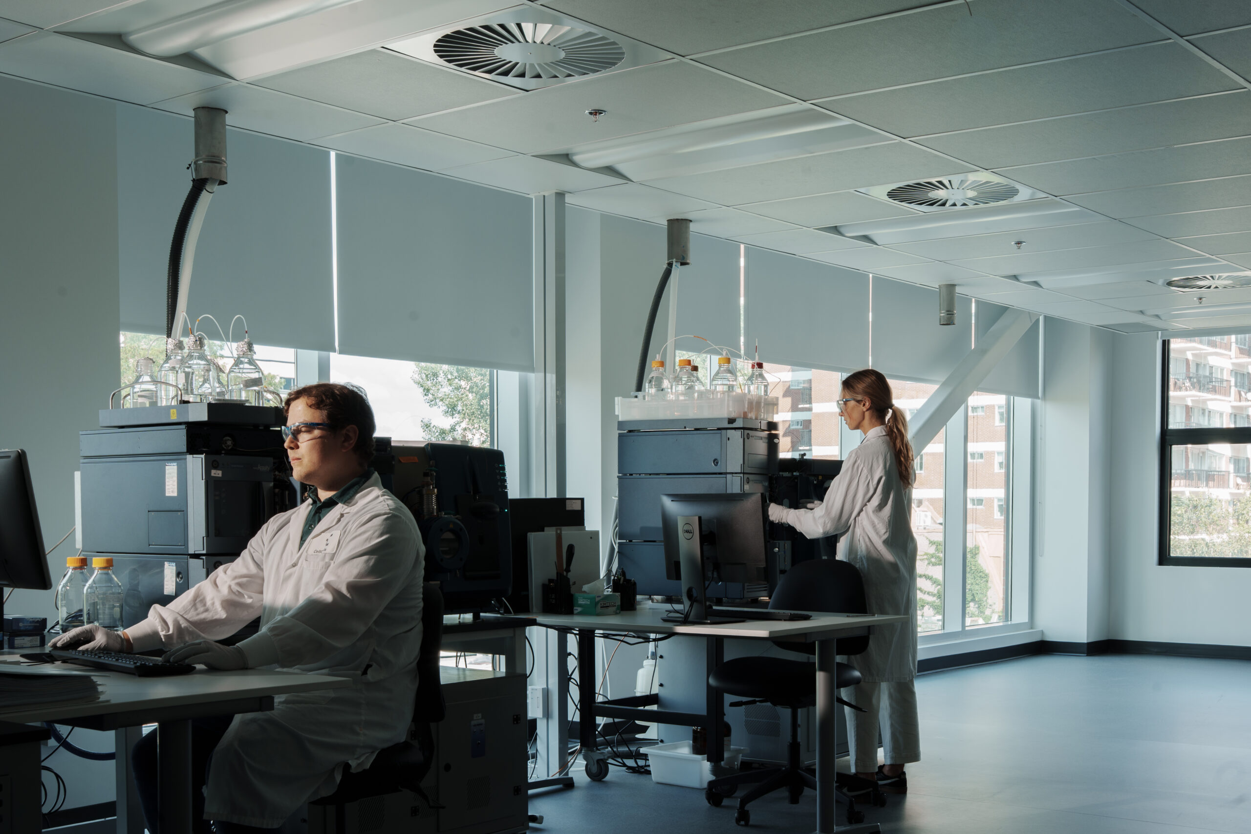 Scientist operating mass spectrometry instruments.