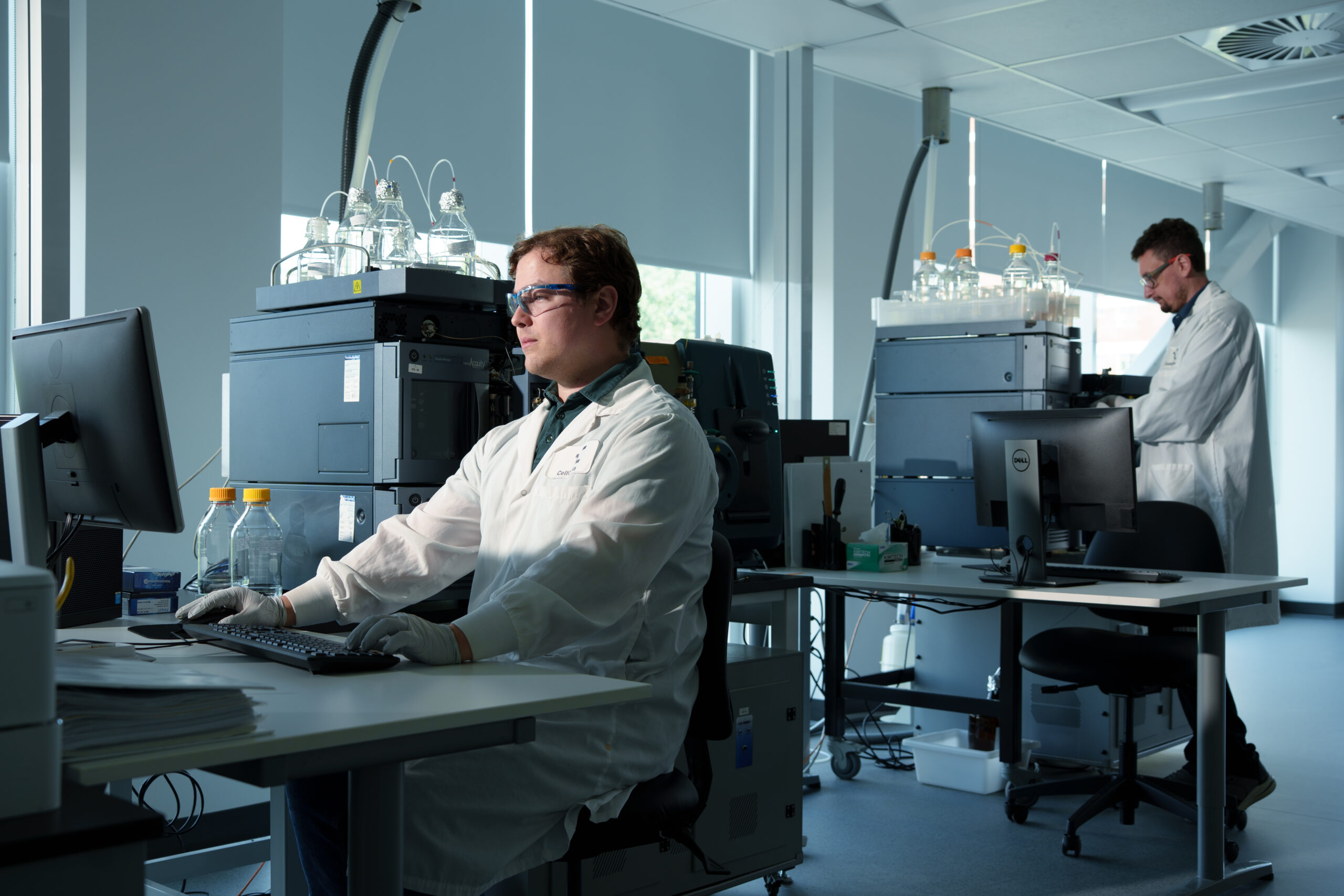 Scientist operating mass spectrometry LC-MS instrument in CellCarta laboratory