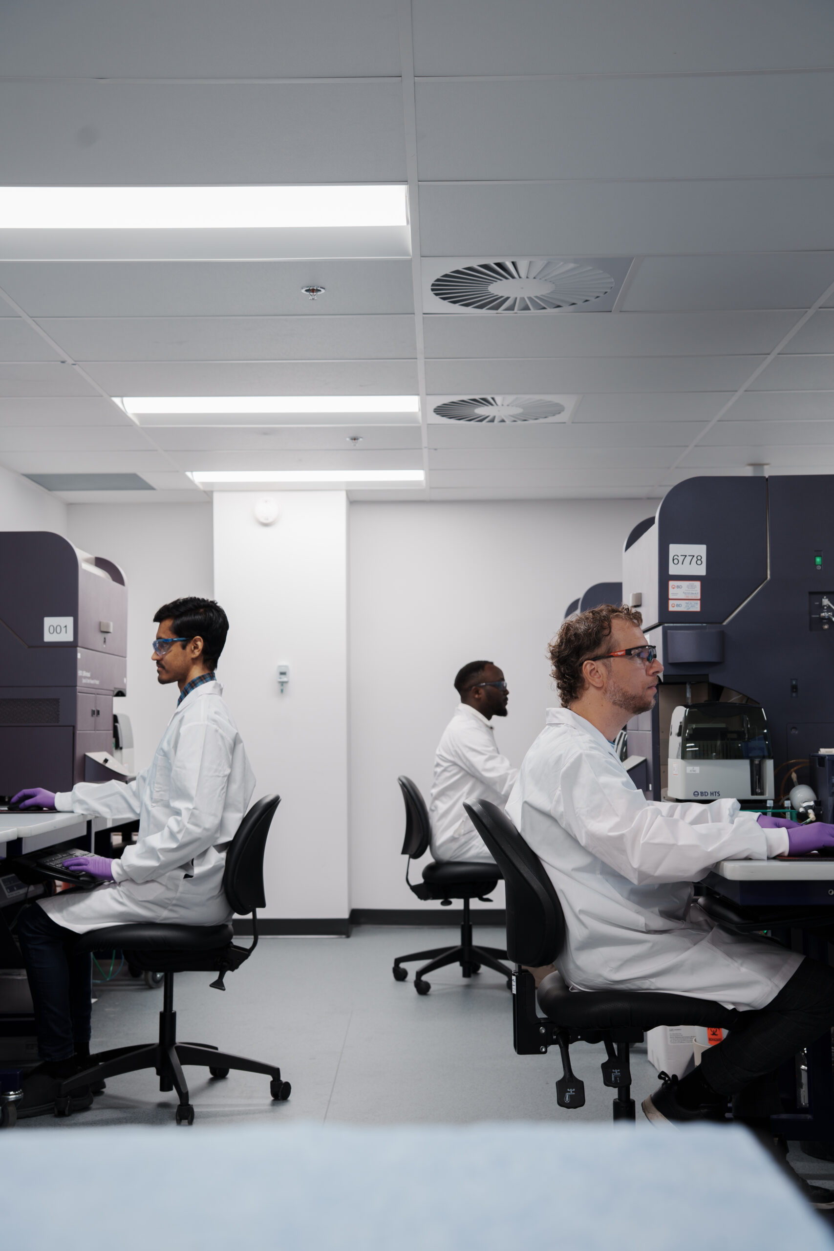 Scientist working at a laboratory workstation.