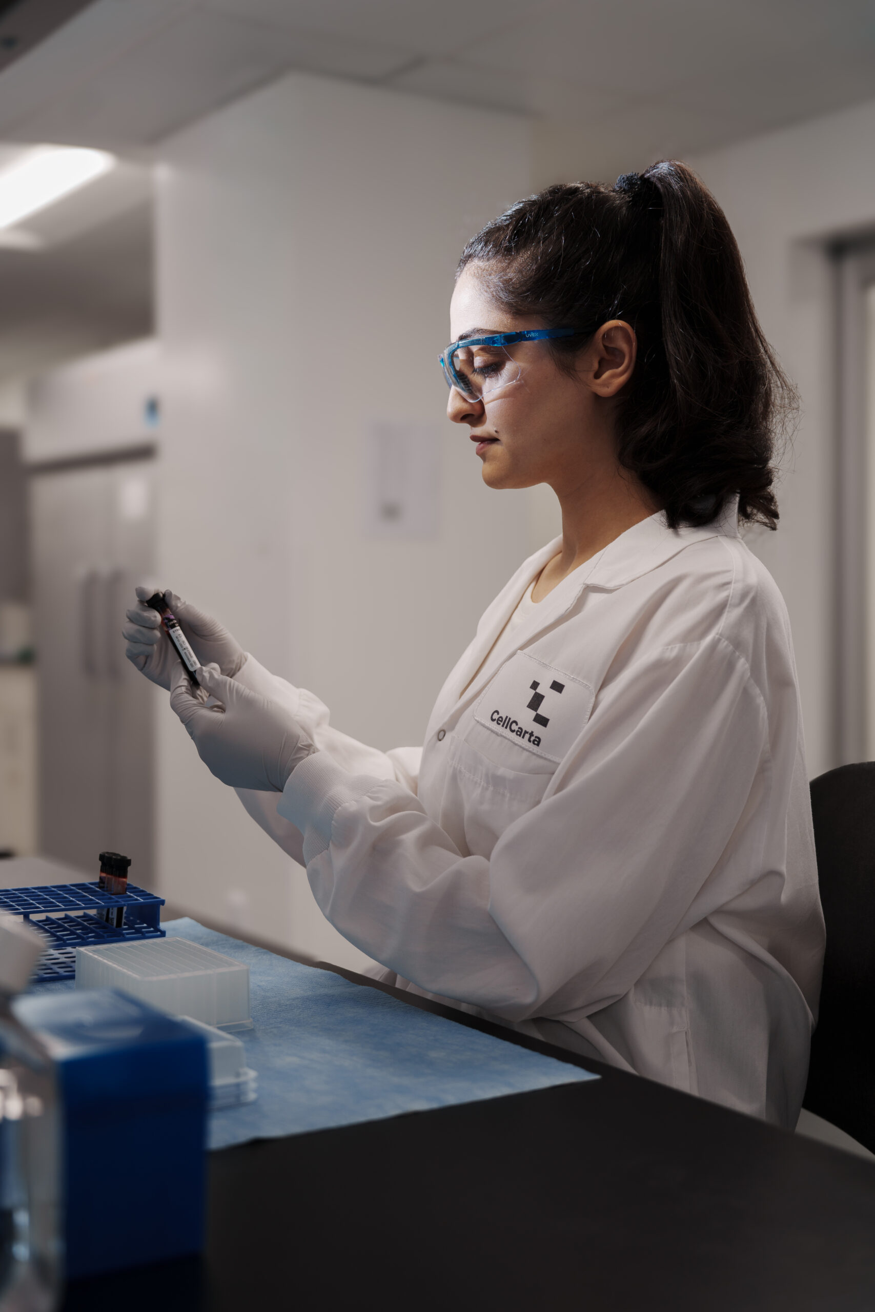 Scientist operating flexible Ella™ platform for multiple sample types