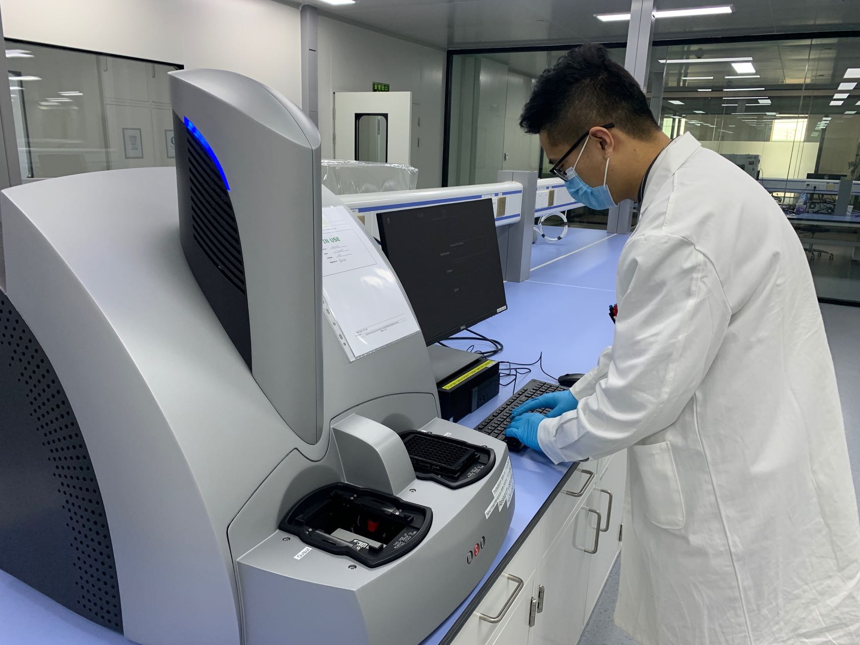 Scientist operating a benchtop MSD instrument.