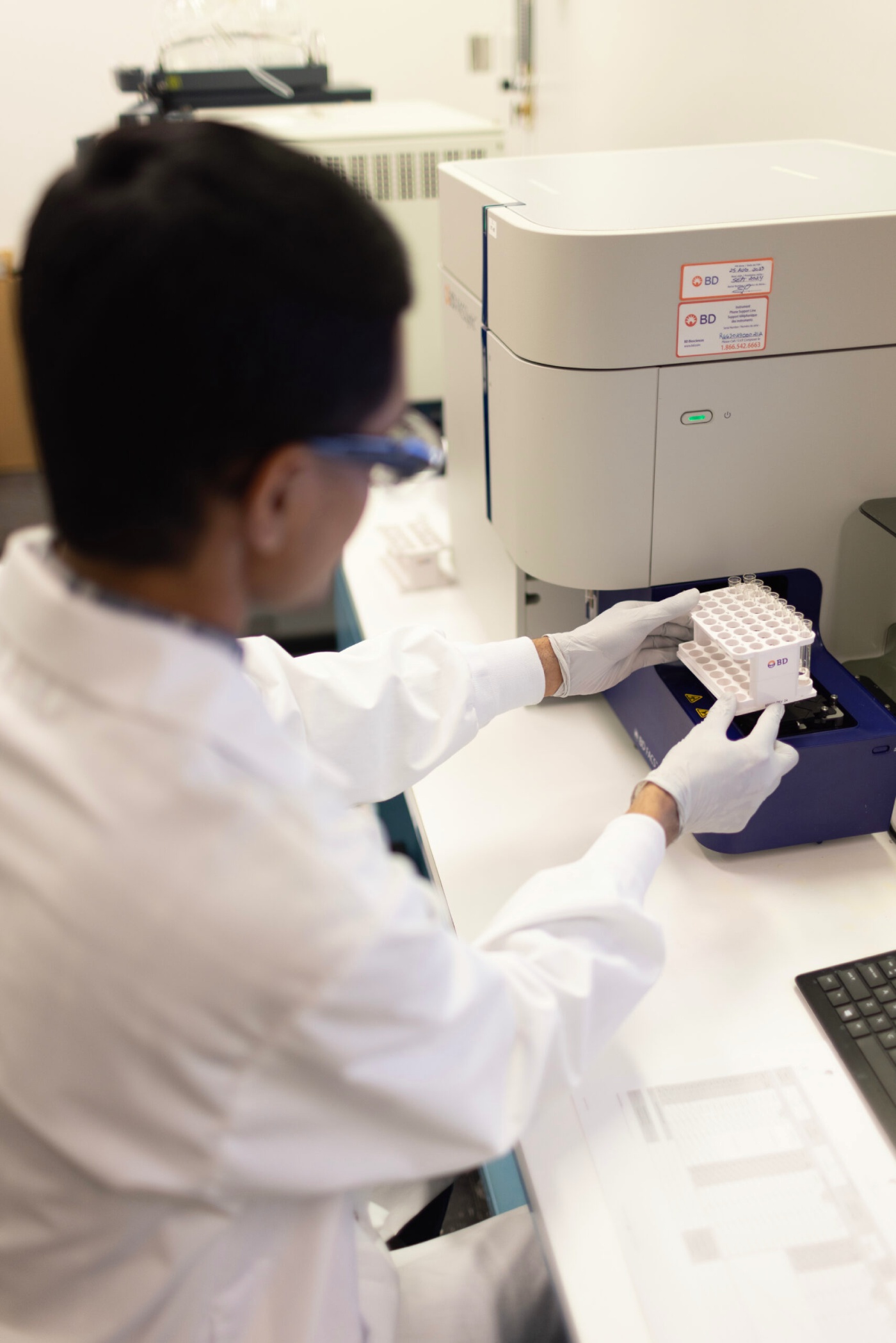 Scientist processing samples at a laboratory bench.